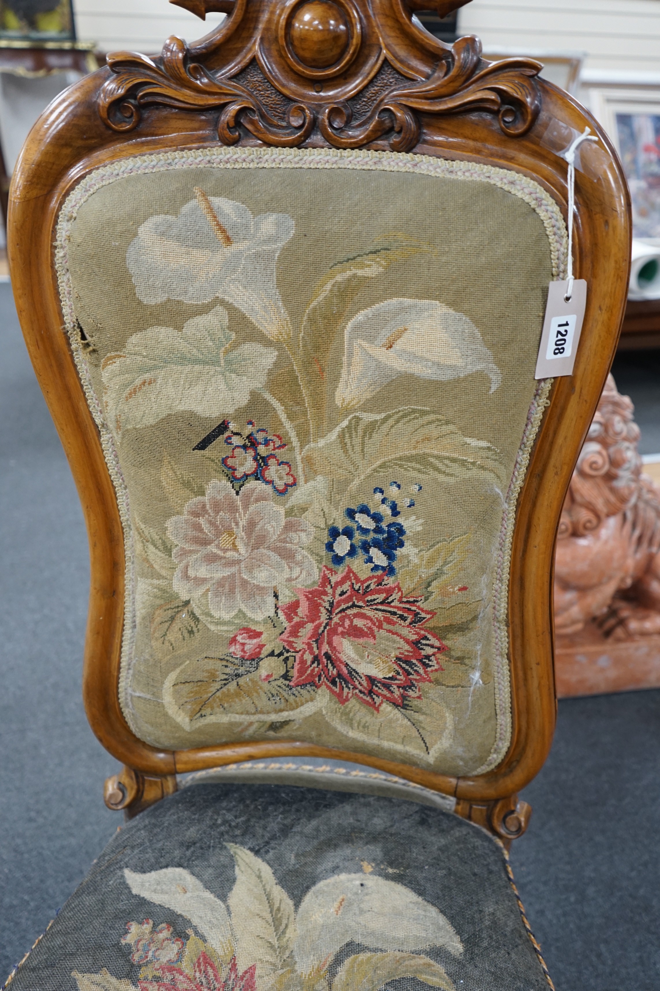 A Victorian carved walnut nursing chair with floral embroidered upholstery, height 112cm